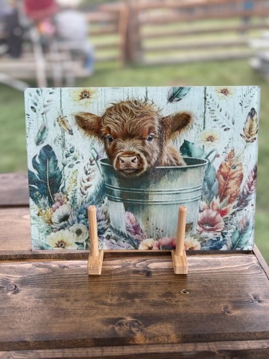 Calf in a Bucket Glass Cutting Board